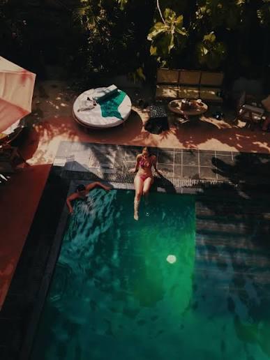Hiri Swimming Club Pool Party at Dots Bay House — tropical pool party with cocktails and sunshine