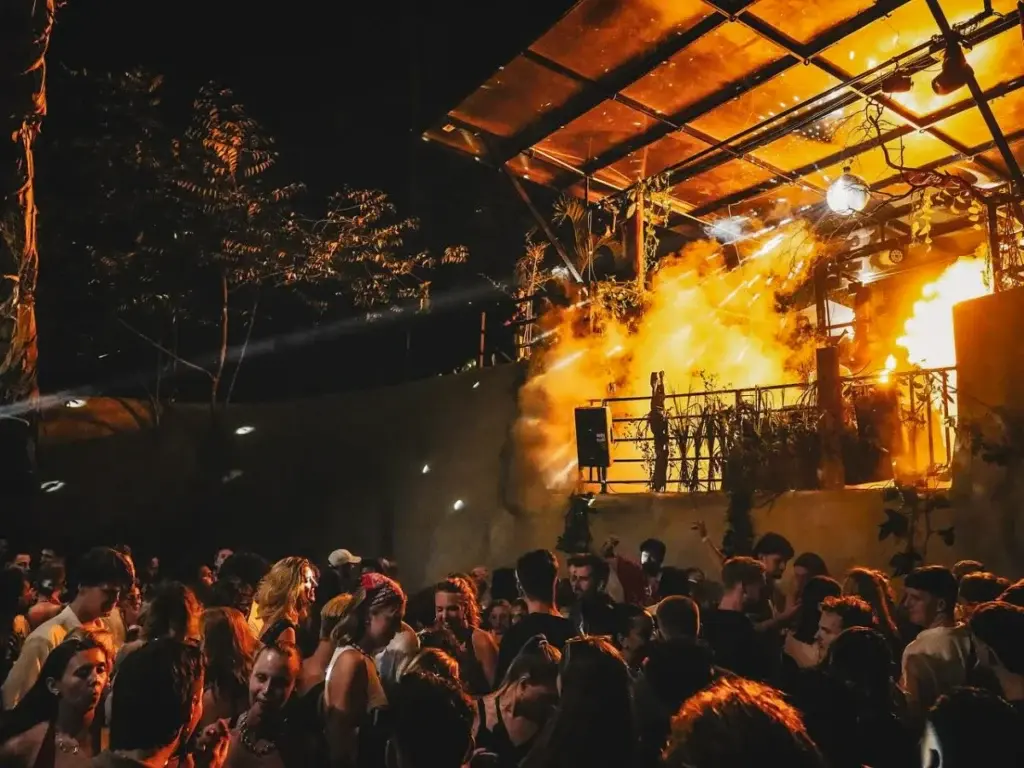 Secret Jungle Party — underground jungle rave in Hiriketiya with neon lights and dancing crowd