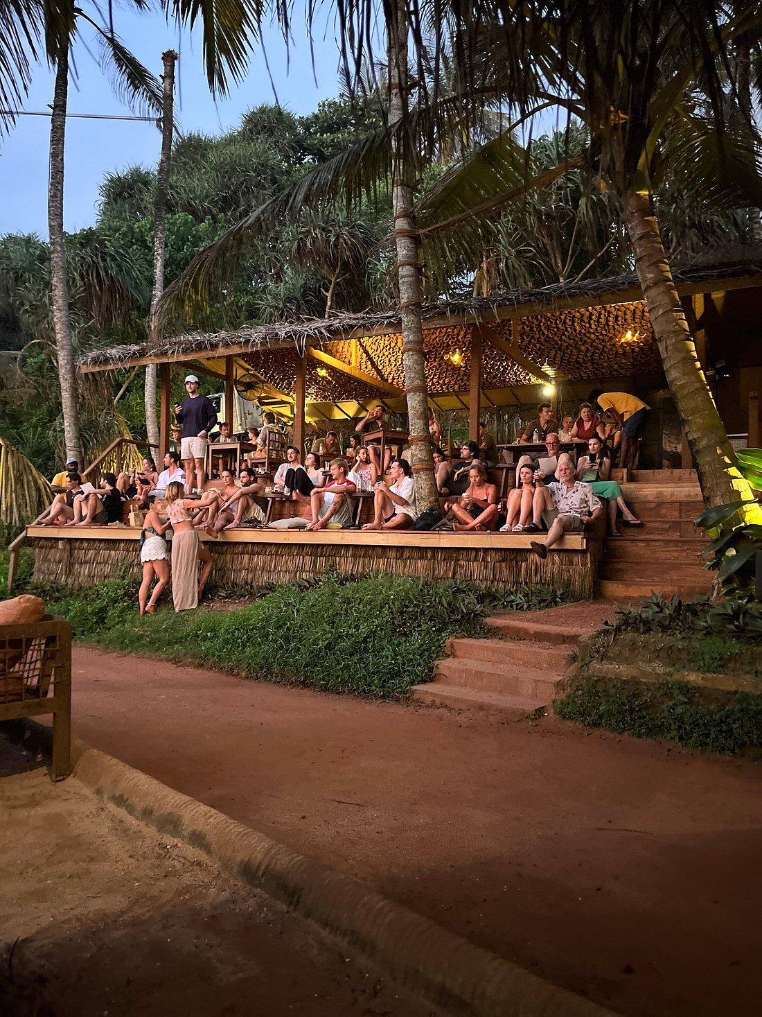 Beachside dining and cocktails at sunset in Hiriketiya Bay