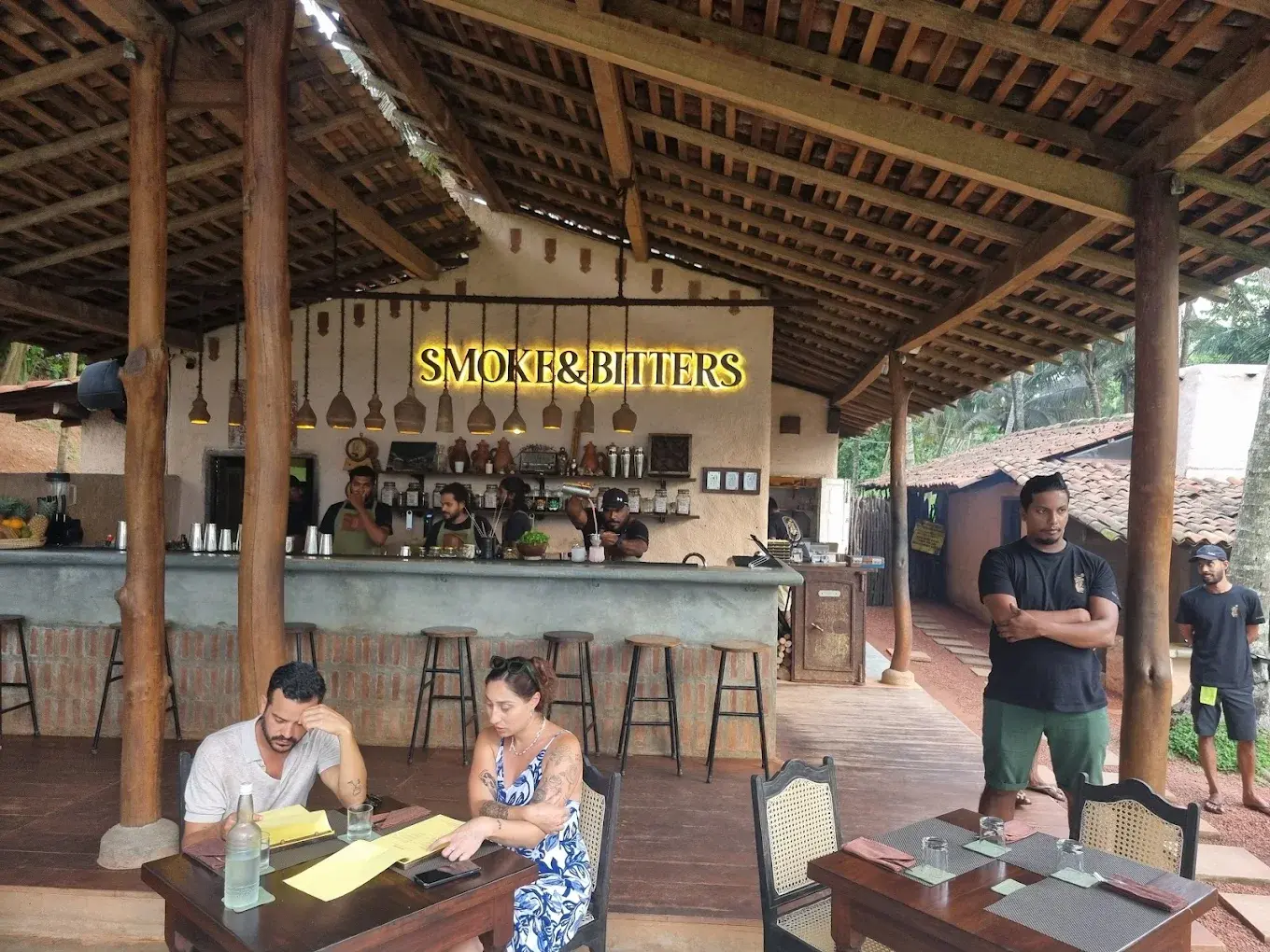 Smoke and Bitters craft cocktail bar in Hiriketiya — warm bar lighting and signature smoke cocktails